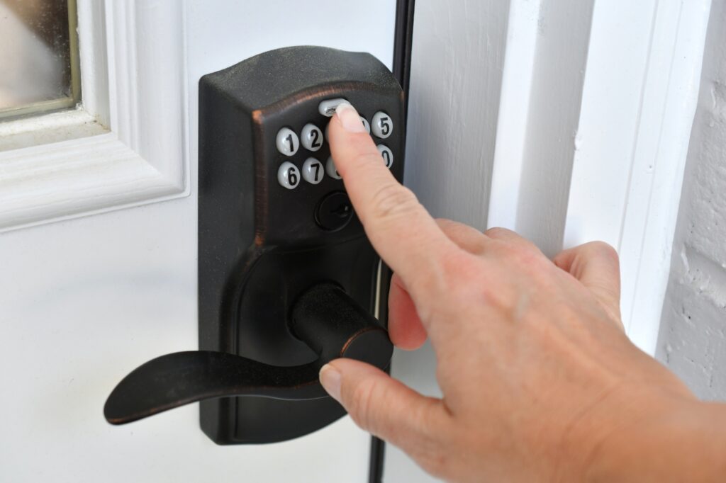 Entering key code PIN on a push button doorknob lock to unlock the door. entering a security code